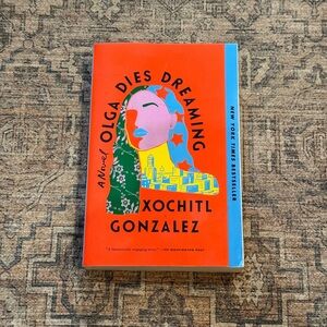 Olga Dies Dreaming by Xochitl Gonzalez - Bright Coral Cover